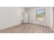 Bedroom features wood-look floors, a window with a view, and a closet at 22050 N 90Th St, Scottsdale, AZ 85255