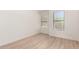 Bright bedroom with natural light, neutral walls, and new light wood-look flooring at 22050 N 90Th St, Scottsdale, AZ 85255