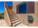 Exterior stairs with iron handrail lead up to a second floor entrance at 22050 N 90Th St, Scottsdale, AZ 85255