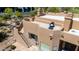 Inviting multi-story home featuring stairs to a cozy rooftop seating area, blending desert elegance and outdoor living at 22050 N 90Th St, Scottsdale, AZ 85255