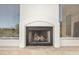 Clean fireplace in a neutral color palette creating a central design element in the home at 22050 N 90Th St, Scottsdale, AZ 85255