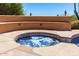 Inviting in-ground hot tub with integrated seating and desert landscaping at 22050 N 90Th St, Scottsdale, AZ 85255