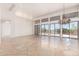 Sun-filled living room with walls of windows providing views and stone flooring offers modern elegance at 22050 N 90Th St, Scottsdale, AZ 85255