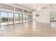 Bright open living room boasts desert views from large windows and stone flooring exudes modern elegance at 22050 N 90Th St, Scottsdale, AZ 85255