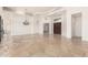 Bright living room with stone floors and detailed ceilings provides modern elegance with easy access to other rooms at 22050 N 90Th St, Scottsdale, AZ 85255