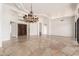 Expansive living room featuring stone floors, custom chandelier and high ceilings offers modern elegance at 22050 N 90Th St, Scottsdale, AZ 85255