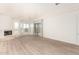Spacious living room featuring a cozy fireplace and large windows with natural light at 22050 N 90Th St, Scottsdale, AZ 85255