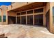 Extended covered patio with neutral tones and stone flooring seamlessly connecting indoor and outdoor living spaces at 22050 N 90Th St, Scottsdale, AZ 85255