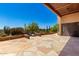 Covered patio with flagstone floor overlooking a lushly landscaped desert backyard and a built-in spa at 22050 N 90Th St, Scottsdale, AZ 85255