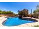 Sparkling pool with desert landscaping featuring cactus and flowering bushes creates a tranquil oasis at 22050 N 90Th St, Scottsdale, AZ 85255