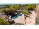 Lush backyard featuring a freeform pool, spa, putting green, and a stone patio for ultimate outdoor enjoyment at 22050 N 90Th St, Scottsdale, AZ 85255
