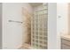 Walk in shower with glass block divider, neutral stone, and modern fixtures at 22050 N 90Th St, Scottsdale, AZ 85255
