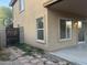 Exterior corner view of the house, highlighting the patio, windows, and a gate to the side yard at 22261 W Tonto St, Buckeye, AZ 85326