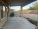 Covered back patio overlooking spacious backyard with block fence; great for outdoor living at 22261 W Tonto St, Buckeye, AZ 85326
