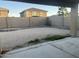 View of the empty backyard with a block wall, patio and potential for landscaping at 22261 W Tonto St, Buckeye, AZ 85326