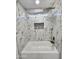 Bathroom boasts marble-patterned tiles, a shower niche, and modern fixtures at 22261 W Tonto St, Buckeye, AZ 85326