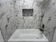 Bathroom boasts marble-patterned tiles, a shower niche, and modern fixtures at 22261 W Tonto St, Buckeye, AZ 85326