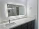 Bathroom featuring dual vanity with marble counters and LED mirrors, plus dark wood cabinets at 22261 W Tonto St, Buckeye, AZ 85326