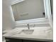 Bathroom vanity featuring a modern sink, light gray countertop and an illuminated mirror at 22261 W Tonto St, Buckeye, AZ 85326