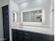 Bathroom featuring dual vanity with marble counters and LED mirrors, plus dark wood cabinets at 22261 W Tonto St, Buckeye, AZ 85326