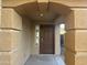 Welcoming home entrance showing a covered porch and a solid front door with a window at 22261 W Tonto St, Buckeye, AZ 85326