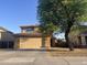 Desirable two-story home featuring a well-kept lawn, tile roof, and attached two-car garage at 22261 W Tonto St, Buckeye, AZ 85326