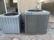 Two gray York HVAC units stand on stone tiles by a wall, offering efficient climate control at 22261 W Tonto St, Buckeye, AZ 85326