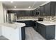 This kitchen features stainless steel appliances, a mosaic backsplash, and stylish gray cabinetry at 22261 W Tonto St, Buckeye, AZ 85326