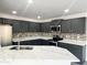 A bright kitchen is equipped with stainless appliances and light countertops at 22261 W Tonto St, Buckeye, AZ 85326