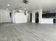 The airy living room is adjacent to the open kitchen and stairway at 22261 W Tonto St, Buckeye, AZ 85326