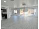 The living room provides access to the backyard and has modern tile floors at 22261 W Tonto St, Buckeye, AZ 85326