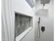 A modern shower with white wave-textured walls, hexagon tiled niche, and a sleek shower system at 22261 W Tonto St, Buckeye, AZ 85326