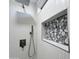 Modern shower featuring textured tile walls, pebble-style accents, and contemporary fixtures at 22261 W Tonto St, Buckeye, AZ 85326