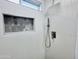 Modern shower featuring stylish gray hexagon tile, a niche, and a handheld shower head at 22261 W Tonto St, Buckeye, AZ 85326