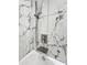 Up-close detail of shower features modern fixtures, a shower niche, and marble-patterned tiles at 22261 W Tonto St, Buckeye, AZ 85326