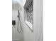 Modern shower featuring textured tile walls, pebble-style accents, and contemporary fixtures at 22261 W Tonto St, Buckeye, AZ 85326