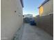 Narrow side yard with block wall, gate, and gravel; ideal for storage or a walkway at 22261 W Tonto St, Buckeye, AZ 85326