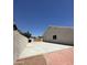 A long concrete backyard area with a wood gate surrounded by masonry walls at 2317 E Lynwood St, Mesa, AZ 85213