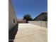Concrete backyard area with masonry walls and view of small shed and neighboring rooftops at 2317 E Lynwood St, Mesa, AZ 85213