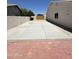 A long concrete backyard area with a wood gate surrounded by masonry walls at 2317 E Lynwood St, Mesa, AZ 85213