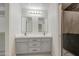 Bathroom with double sink vanity, modern lighting, and tiled shower for a spa-like experience at 2317 E Lynwood St, Mesa, AZ 85213