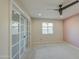 Bedroom with a ceiling fan, a sliding closet, and neutral paint at 2317 E Lynwood St, Mesa, AZ 85213