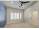 Bedroom featuring vaulted ceilings, an accent wall, plantation shutters and glass doors at 2317 E Lynwood St, Mesa, AZ 85213