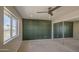Bedroom showcasing a designer accent wall, natural light and mirrored closet doors at 2317 E Lynwood St, Mesa, AZ 85213