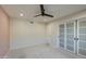 Cozy bedroom features modern closet, neutral paint, and ceiling fan at 2317 E Lynwood St, Mesa, AZ 85213