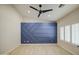 Bedroom featuring vaulted ceilings, an accent wall, and plantation shutters at 2317 E Lynwood St, Mesa, AZ 85213