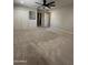 Bright bedroom featuring carpet, ceiling fan, built-in cabinet, and double door closet at 2317 E Lynwood St, Mesa, AZ 85213