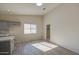 Well-lit dining area with wood-look tile flooring next to kitchen and laundry room at 2317 E Lynwood St, Mesa, AZ 85213