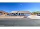 Charming single-story home with a tile roof, desert landscaping, and an attached two-car garage at 2317 E Lynwood St, Mesa, AZ 85213