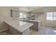 Modern kitchen with white countertops, grey cabinetry, and stainless steel appliances at 2317 E Lynwood St, Mesa, AZ 85213